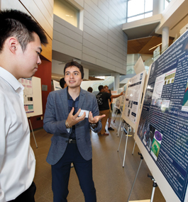 Two students discuss a poster at SciFest